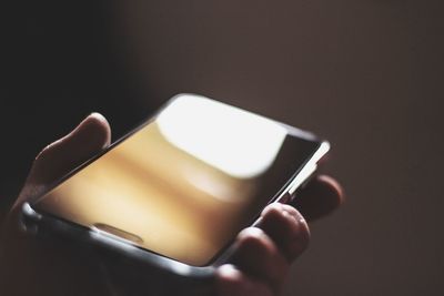 Close-up of human hand holding smart phone