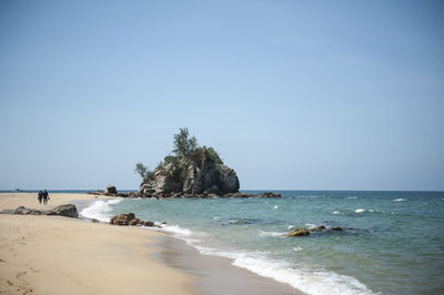 Scenic view of beach against clear blue sky