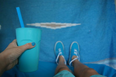 Low section of woman holding mug