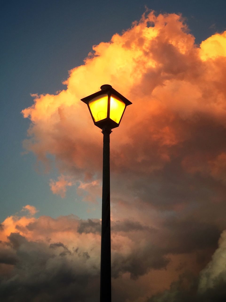 low angle view, sky, sunset, cloud - sky, street light, lighting equipment, cloudy, cloud, silhouette, orange color, nature, tranquility, beauty in nature, pole, scenics, weather, yellow, dusk, dramatic sky, outdoors
