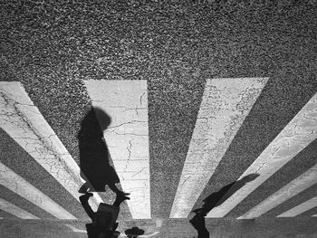 Upside down view of people walking on zebra crossing