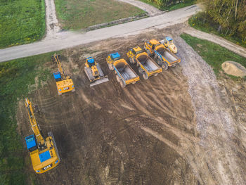 Excavators and dump trucks working during the construction of the viaduct on the drôme river. 