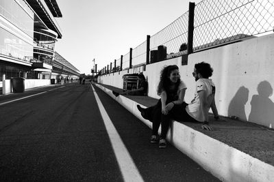 Full length of woman standing by railing