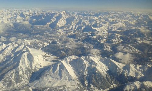 Scenic view of snow covered mountains against sky