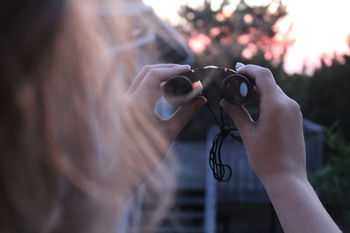 Close-up of hand holding binoculars