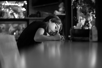 Side view of girl studying on table