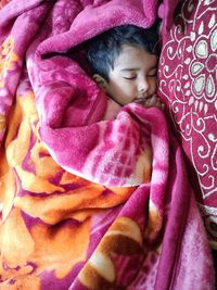 High angle view of cute baby sleeping on bed