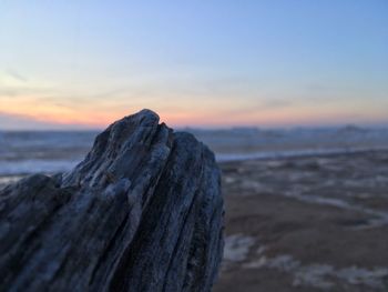 Close-up of sea against sky at sunset