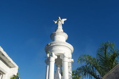 Low angle view of statue against blue sky