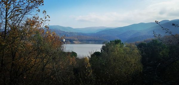 Scenic view of lake and mountains against sky