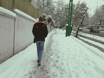 People walking on snow covered landscape