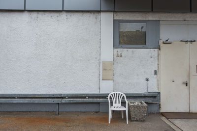 Empty chair against building