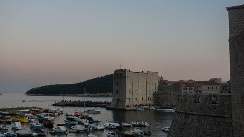 Buildings in city against clear sky