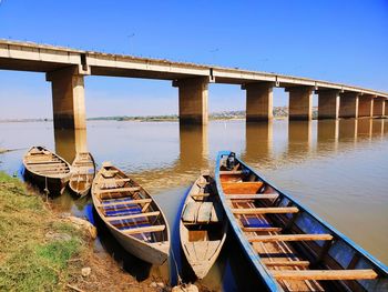 Bridge over river against clear blue sky