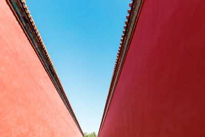 Low angle view of red building against clear sky
