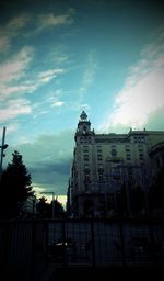 Low angle view of building against cloudy sky