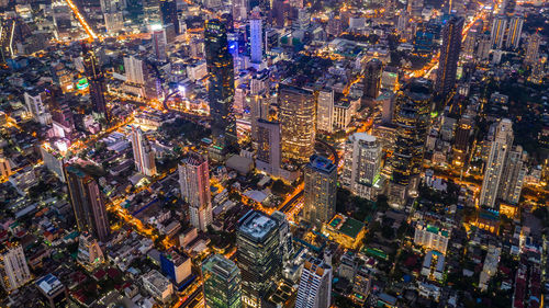 High angle view of city lit up at night