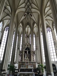 Low angle view of stained glass window in building