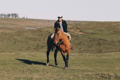 Man riding horse on field