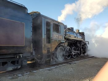 Train on railroad tracks against sky
