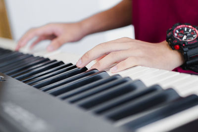 Close-up of hands playing piano