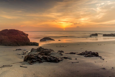 Scenic view of beach against sky during sunset