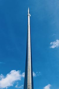 Low angle view of tower against blue sky