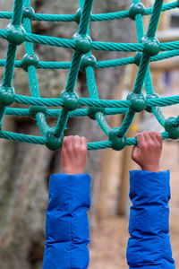 Midsection of person holding rope