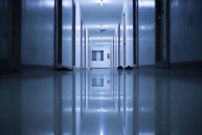 Surface level of tiled floor in illuminated corridor