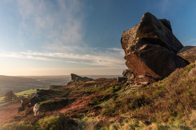 Rock formations on landscape against sky