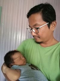 Close-up of father with baby girl at home