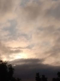 Low angle view of silhouette trees against sky during sunset