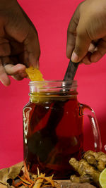 Close-up of hand holding glass jar