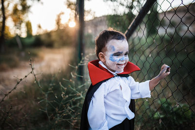 Portrait of a boy standing on field