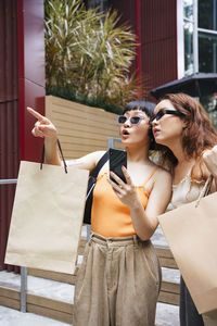 Young woman wearing sunglasses standing outdoors