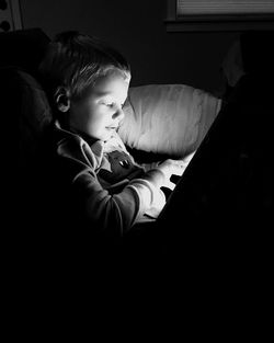 Portrait of cute boy sitting outdoors