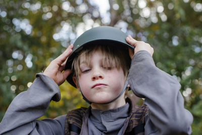 Portrait of boy wearing sunglasses against trees