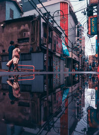 Full length of woman on building in city