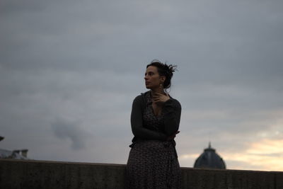 Low angle view of two people standing against sky