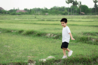 Full length of boy standing on field