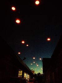 Low angle view of illuminated building against sky at night