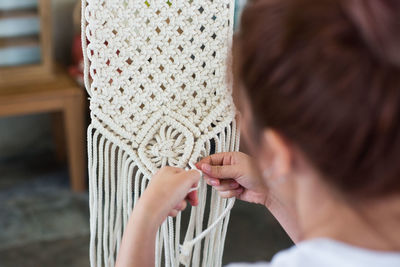 Close-up of woman knitting at home