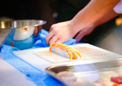 Cropped hand of person working on table