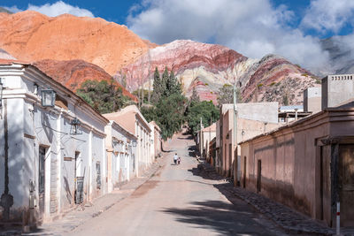 Street amidst buildings against sky