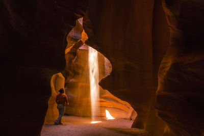 Man standing in illuminated room