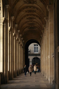 People walking in corridor of building