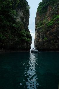Scenic view of rock formation in sea against sky