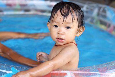 Close-up of shirtless boy in swimming pool