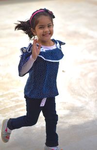 Portrait of smiling girl standing outdoors