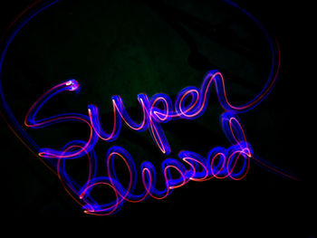 Illuminated light painting against black background